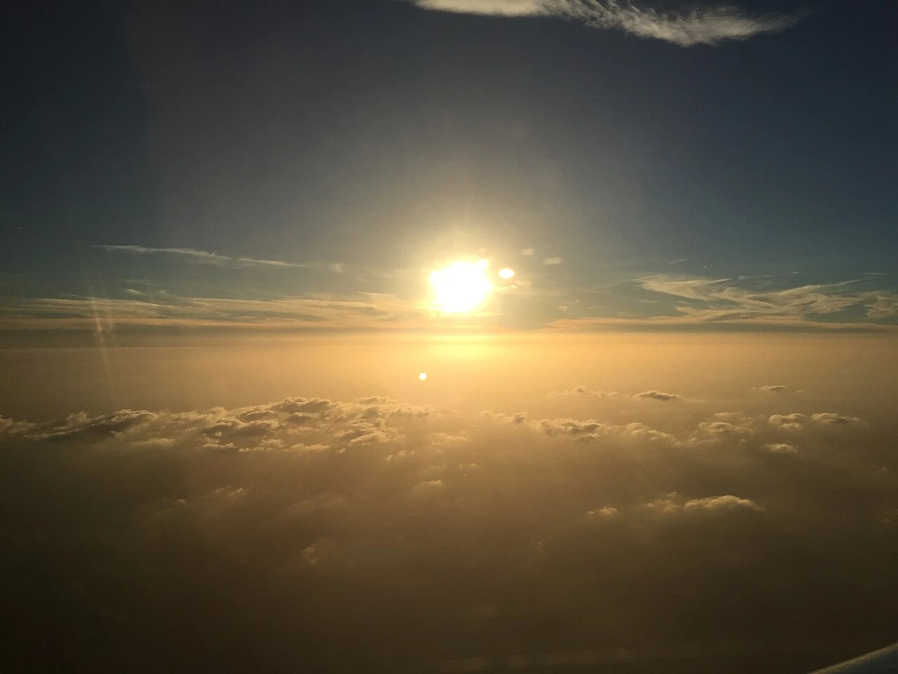 Sun near sunset shining through low-level dust over Collin County, Texas viewed from an airplane flying from Washington Dulles International Airport to Dallas-Fort Worth International Airport