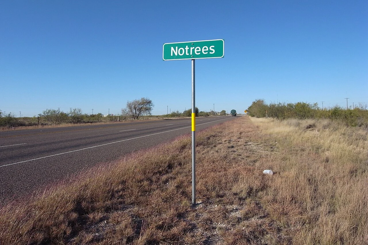 Notrees, Texas along Texas State Highway 302 with trees in background.