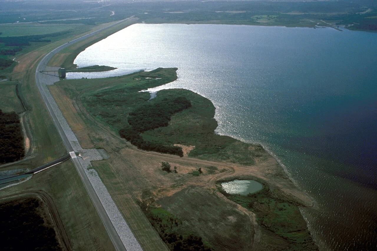 Aerial view of Joe Pool Lake and Dam in the Dallas-Fort Worth metropolitan area between Dallas and Fort Worth. Joe Pool Lake is mostly fed by Mountain Creek and Walnut Creek and drains north into Mountain Creek leading into Mountain Creek Lake. Joe Pool lake impounds water in two arms formed by Mountain Creek and Walnut Creek. The lake serves as a reservoir for the City of Midlothian. View is to the east.