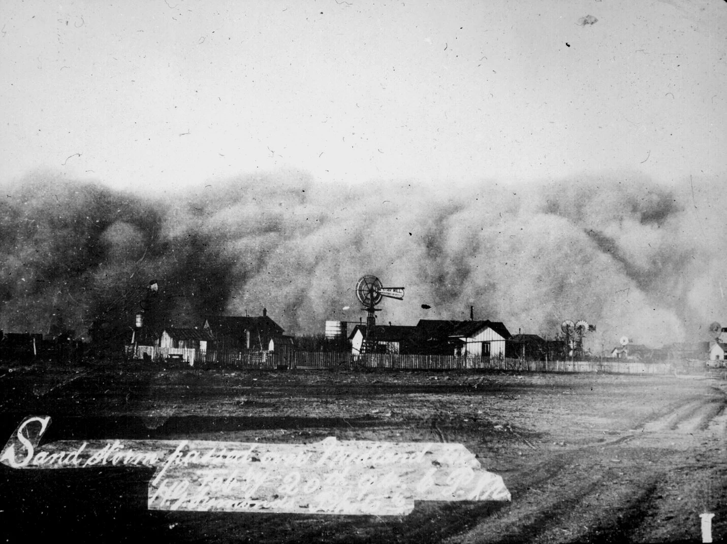 Sand storm that passed over Midland, Texas , February 20, 1894 at 6:00 p.m. Windmills and houses visible just below the whirling sand.