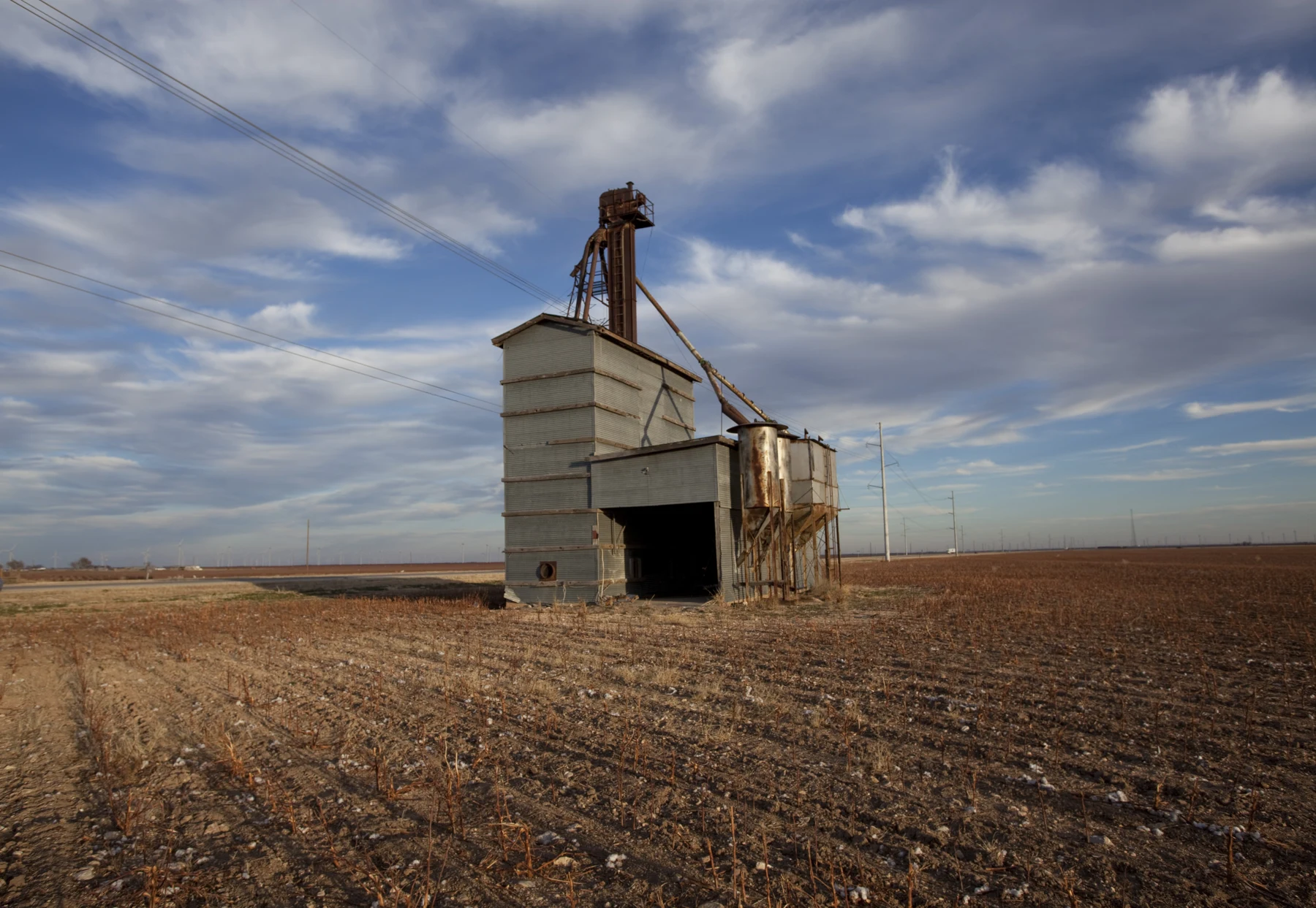 Abandoned grain elevator in Wastella of Nolan County, Texas .