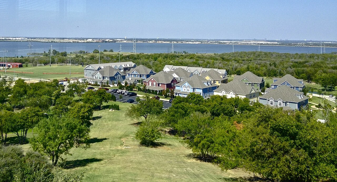 The north side of the Dallas Baptist University campus, showing the Colonial Village residences. Mountain Creek Lake in the distance.