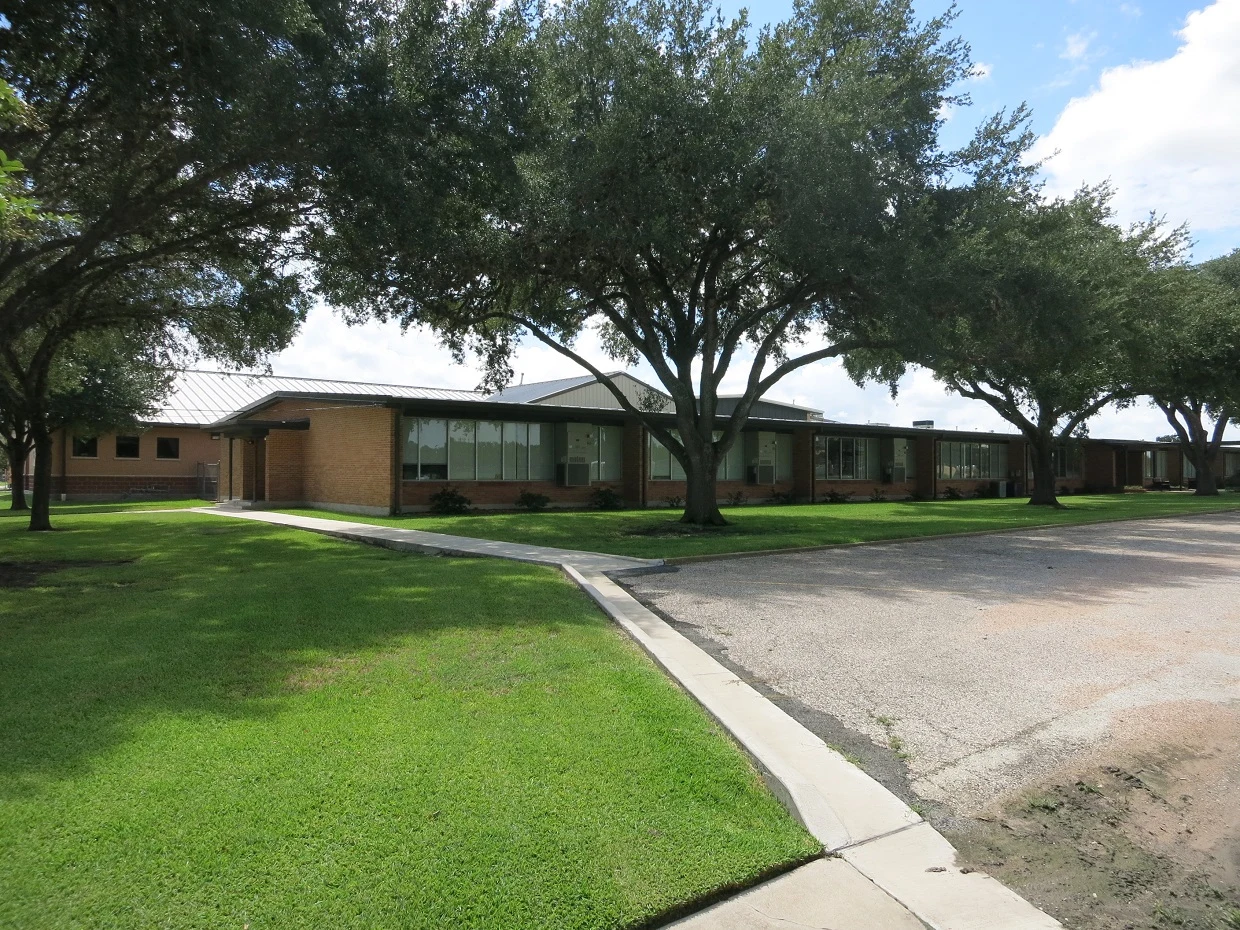 Photo shows Hallettsville Junior High School at 410 S Russell Street, Hallettsville, TX 77964. The view is to the south.