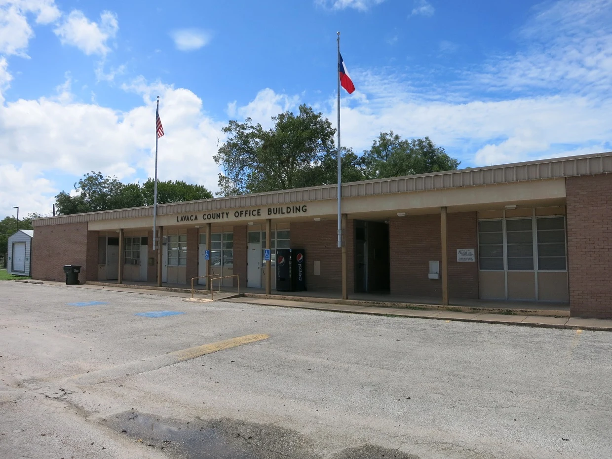 Photo shows the Lavaca County Office Building at 312 S LaGrange Street, Hallettsville, TX 77964. View is toward the southwest.