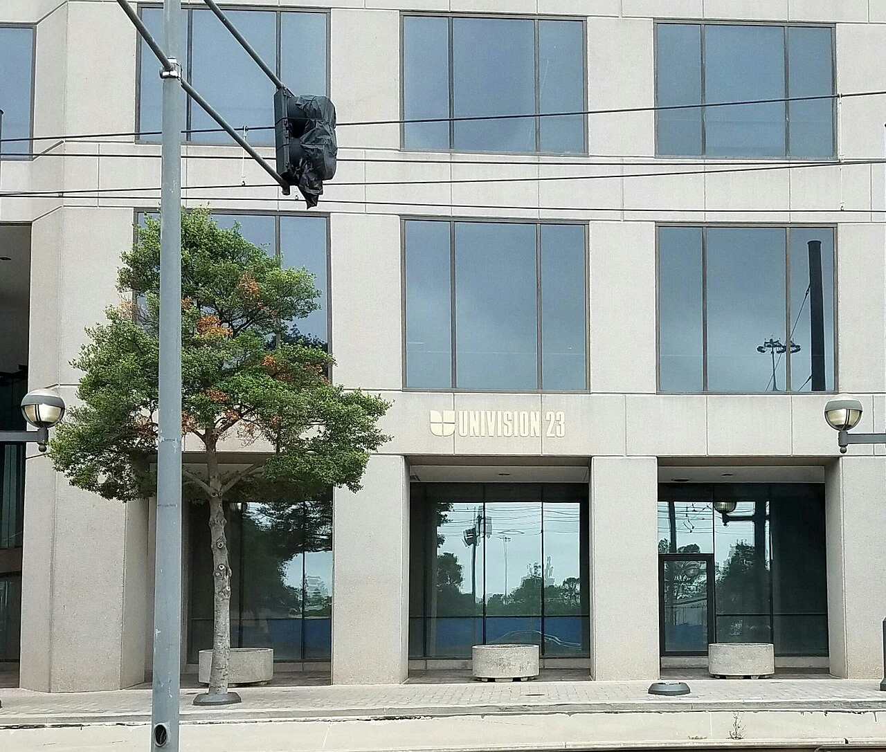 Front of office building for KUVN, with 'Univision 23' sign appearing near the front door.