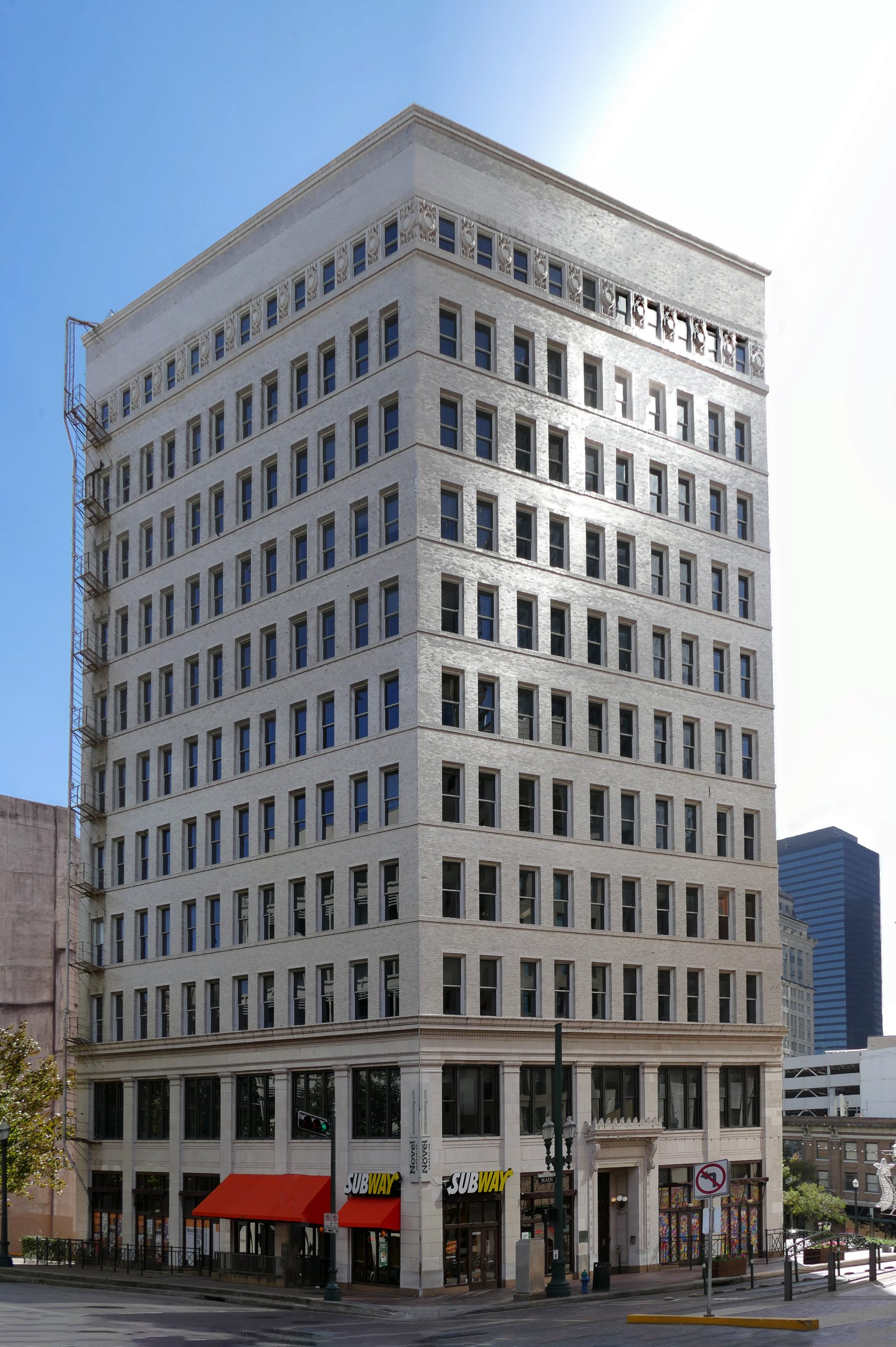This building was built by two daughters as a monument to their deceased father, T.H. Scanlan, one Houston's former mayors. When the building opened on August 1, 1909, it was billed as the "largest building in the largest city in the largest state". The building is located on the site of the Texas Executive Mansion, where Sam Houston and Mirabeau Lamar lived while serving as President of the Republic of Texas.